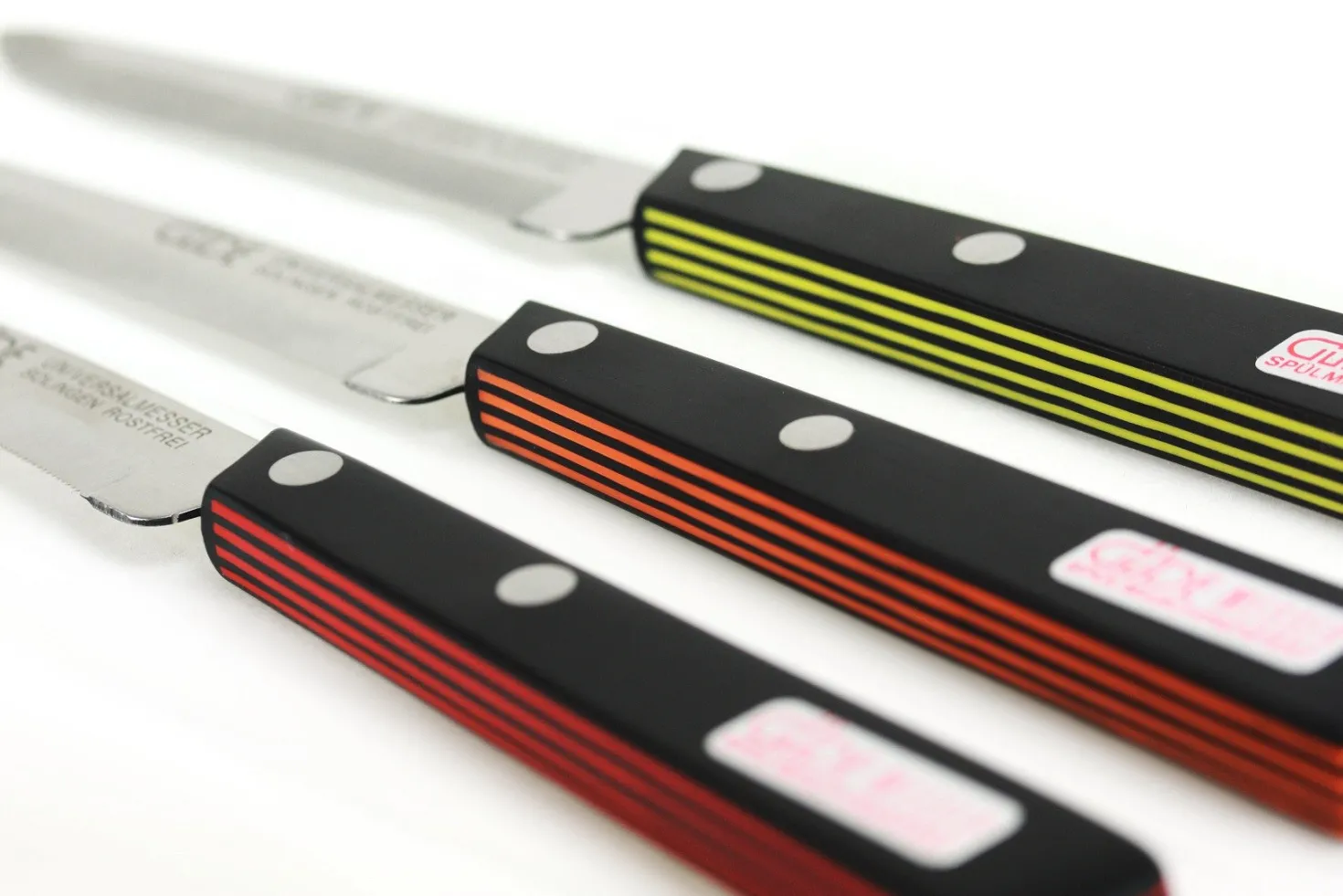 Couteau de table GÜDE Universel 10cm micro-denté manche noir/rouge